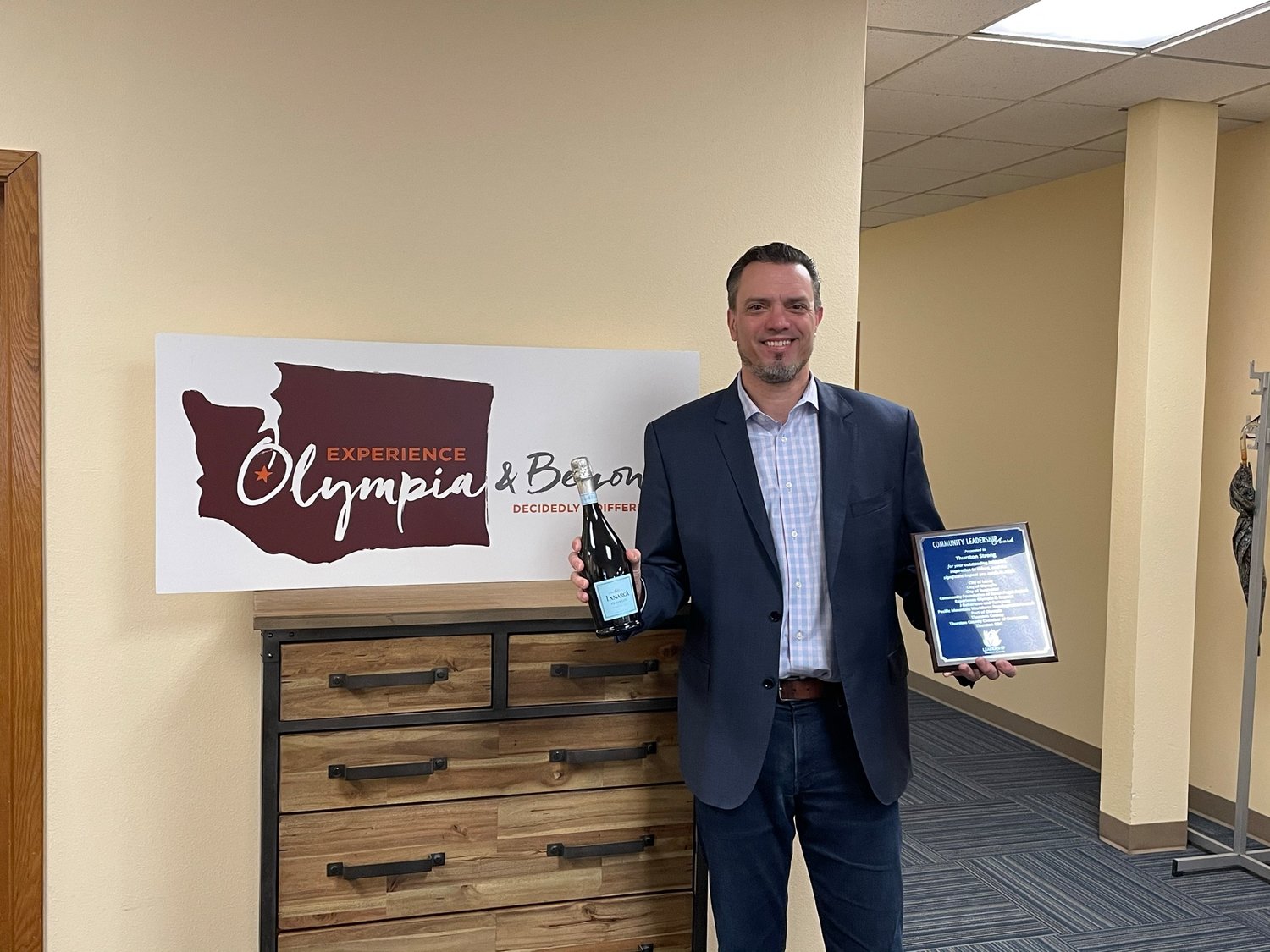 Jeff Bowe, Interim Executve Director of Experience Olympia & Beyond, accepts the 2020 Community Leadership Award from Leadership Thurston County (LTC) for the organization's part in the Thurston Strong initiative.